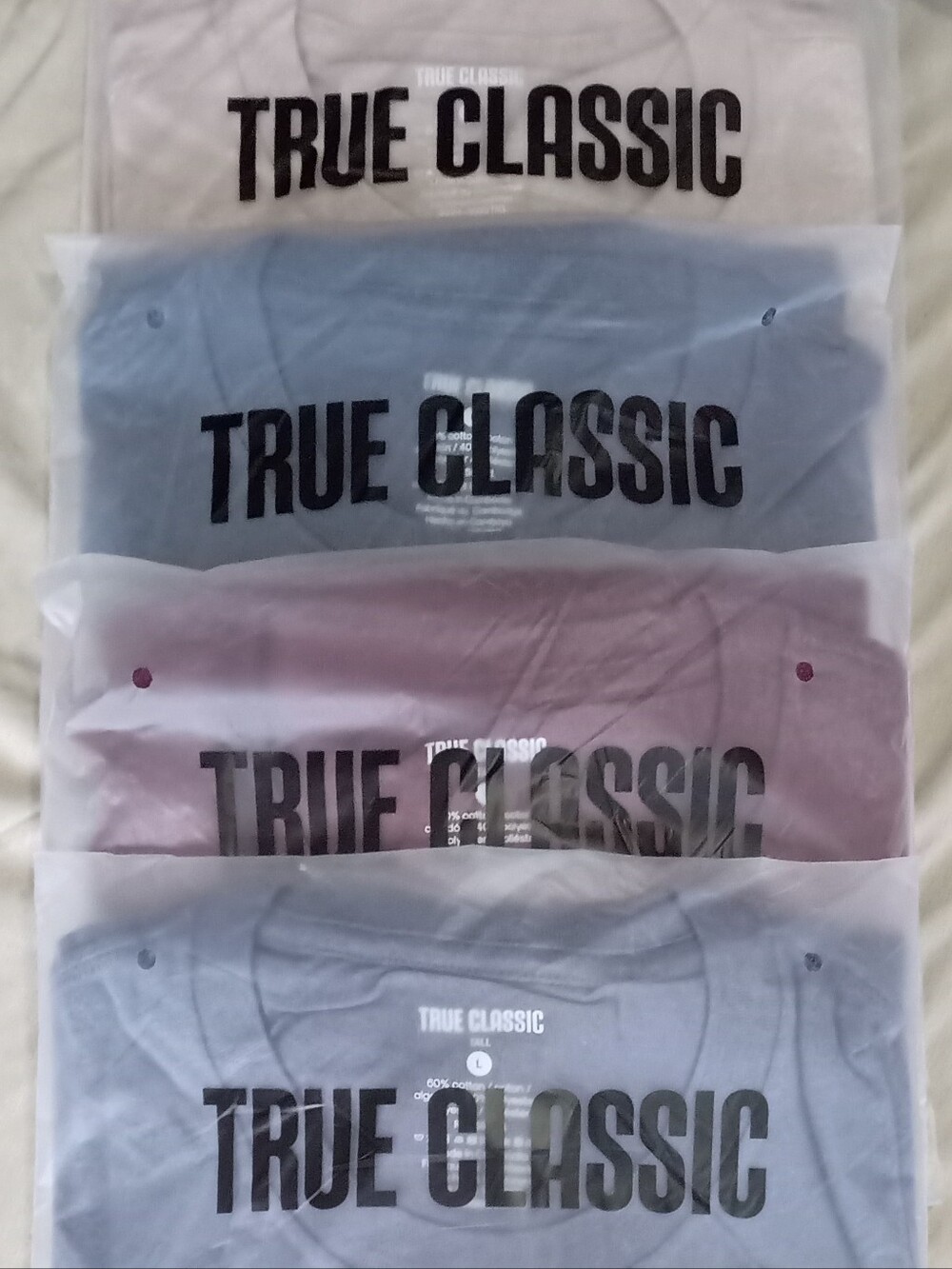4 Pk. True Classic Men’s Short Sleeve Tee Shirts. Two Blue. One Red. One Beige.